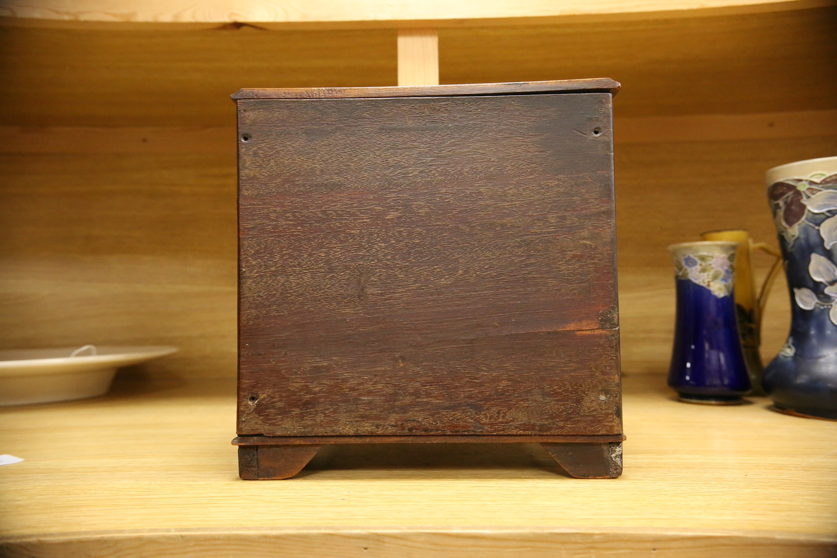 An Edwardian miniature mahogany three drawer chest, 26cm wide x 28cm high. Condition - fair to good